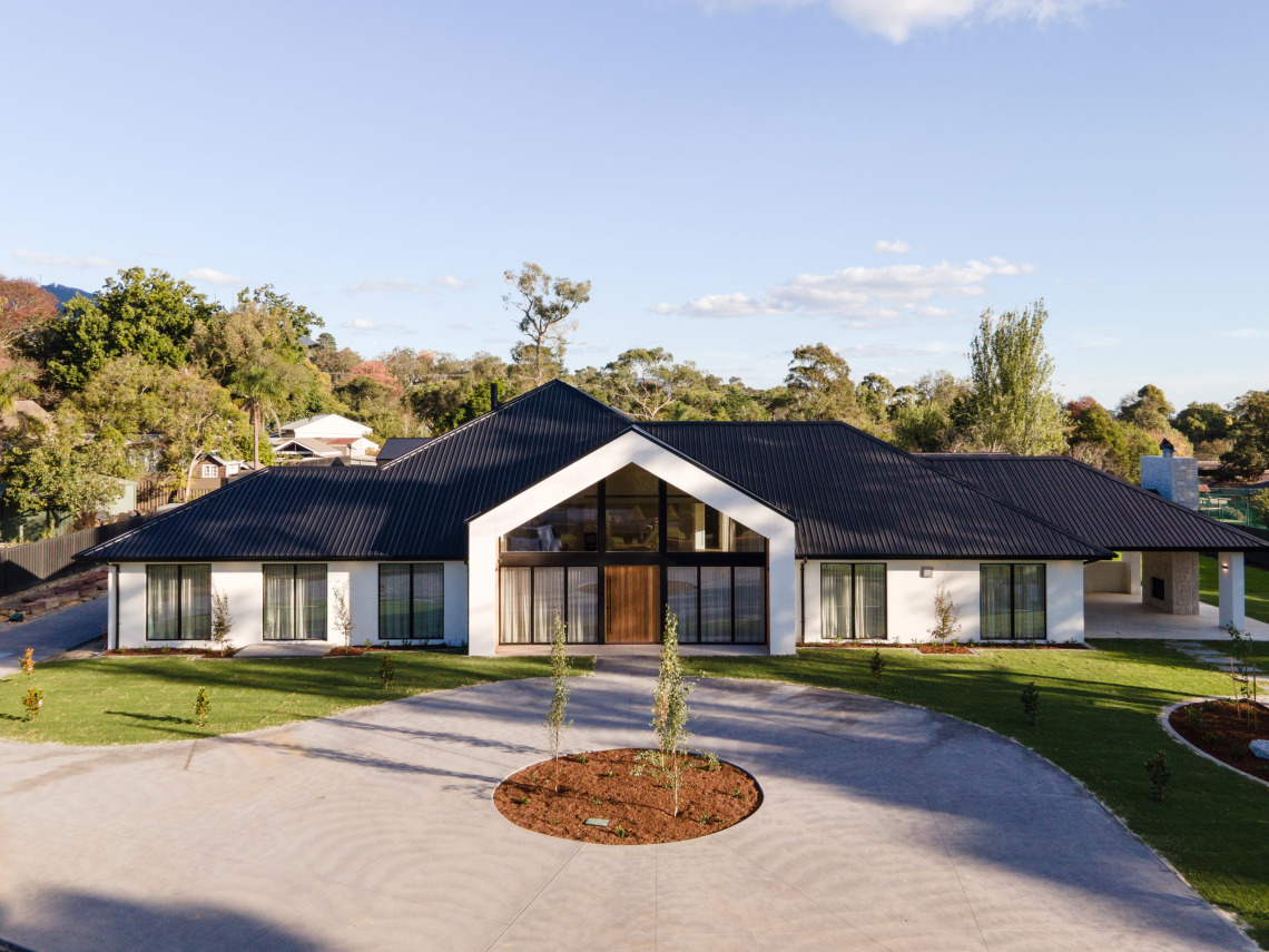 Aerial view of a new Mooroolbark home by Impressive Homes with a full-height raked glass gable entry