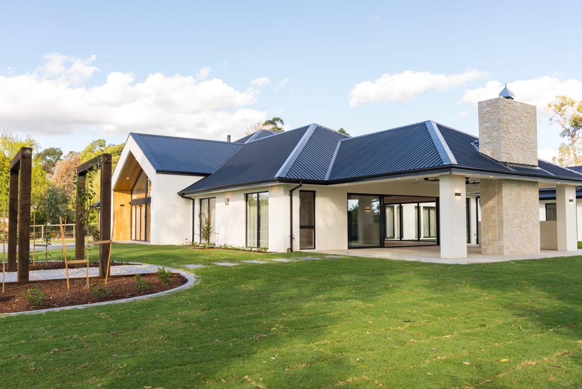 Rear of a Mooroolbark home with black-framed Signature awning windows and doors onto the lawn