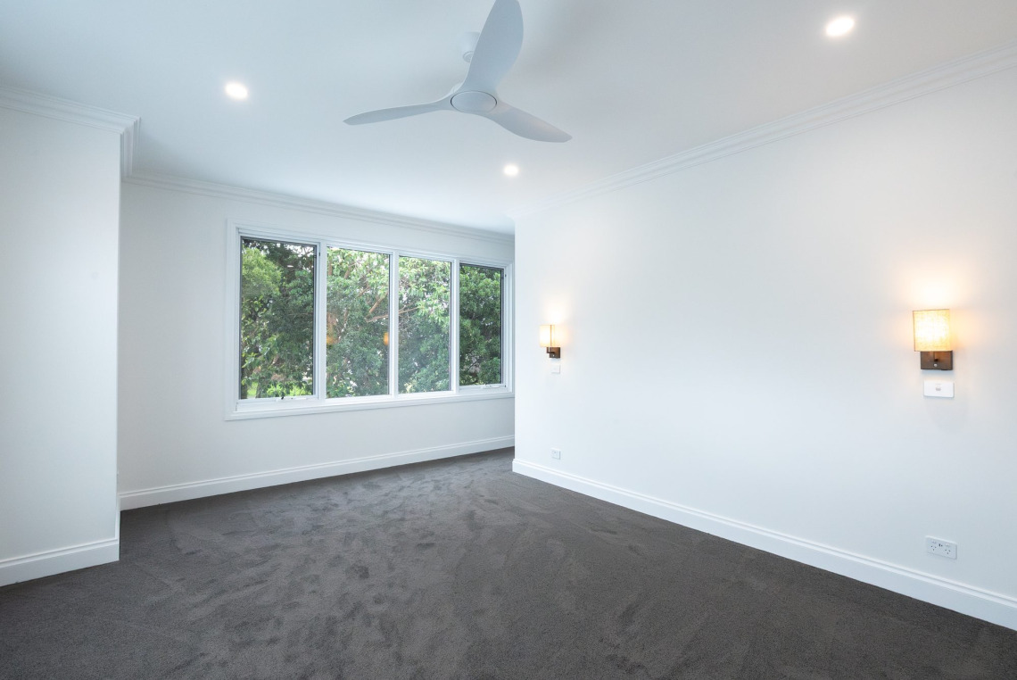 Bedroom with a bank of white aluminium awning windows, Ringwood North