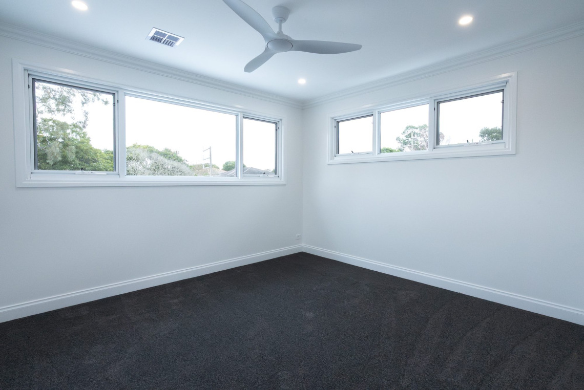Bedroom with white aluminium highlight awning windows, Ringwood North