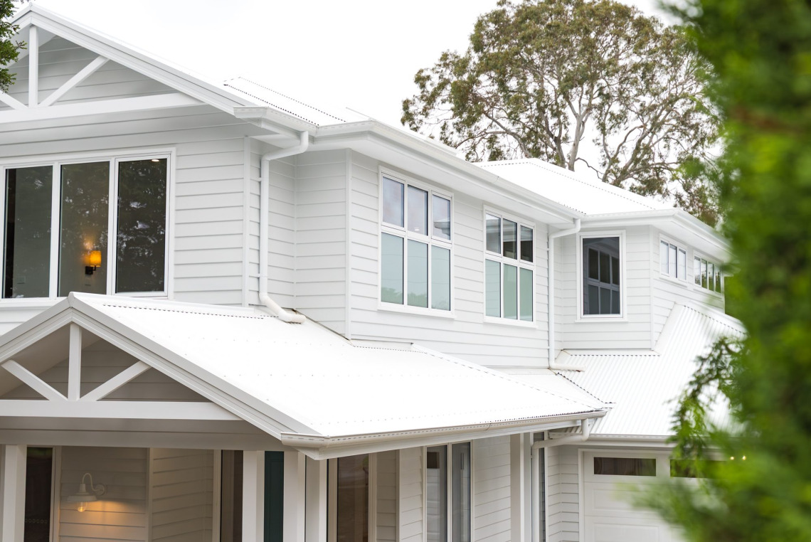 Upper-floor white aluminium awning windows on a weatherboard home in Ringwood North