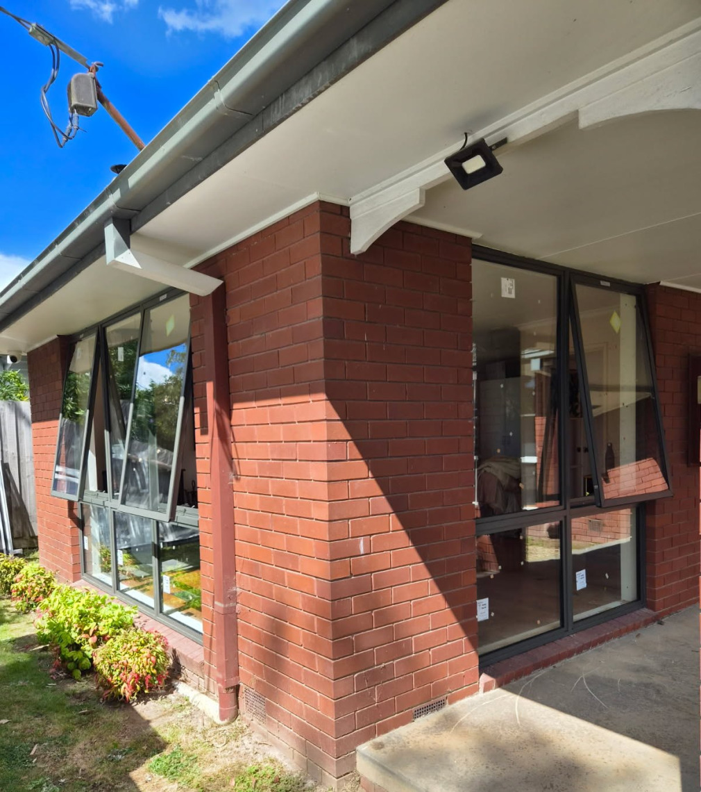 Black aluminium windows installed on a brick home after a window replacement
